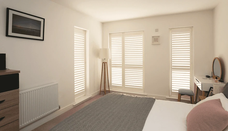 Close-up bedroom shutter installation showing neat fit and clean detailing.
