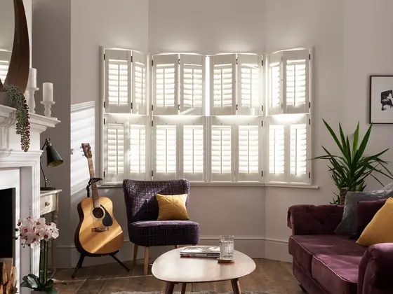 White Antigua plantation shutters on a bay window.