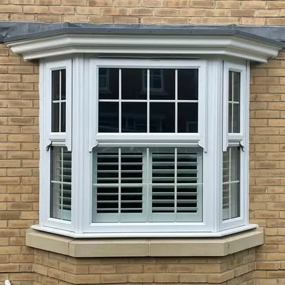 Exterior view of a bay window with fitted shutter panels.