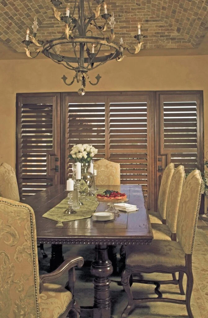 French door shutters in a dining room with rich timber finish.