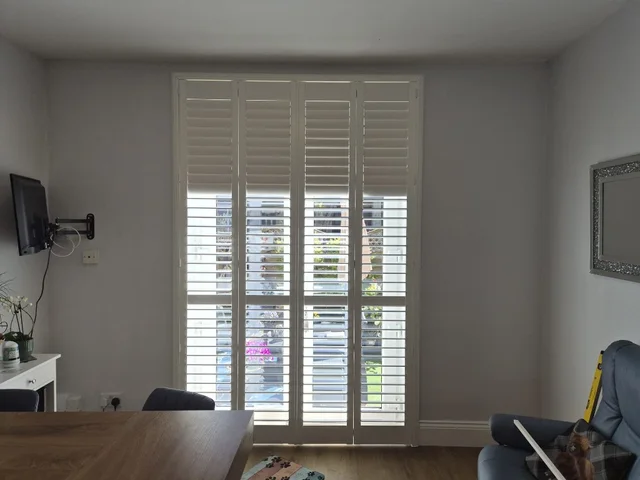 Plantation shutters on inward-opening French doors
