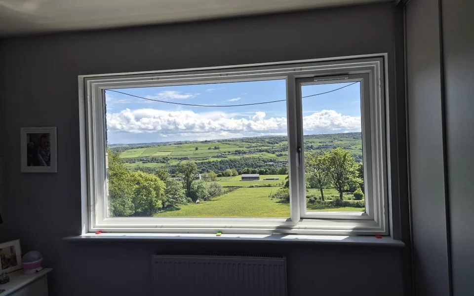 Halifax bedroom with a wide white-framed window before plantation shutters were installed.
