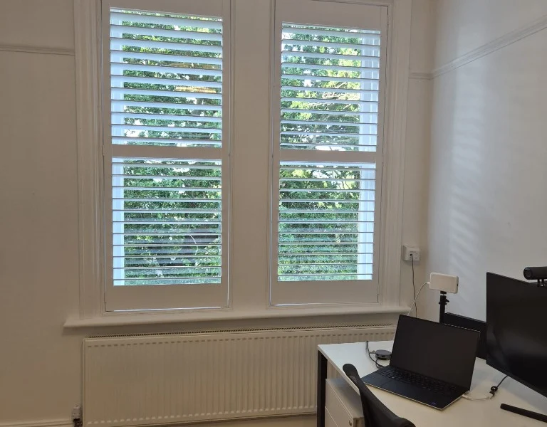 Harrogate home office after white tier-on-tier plantation shutters were fitted to the sash window.
