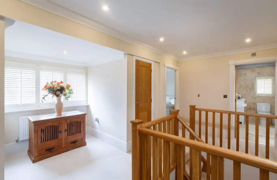 Premium white plantation shutters installed in a bright, modern living space.