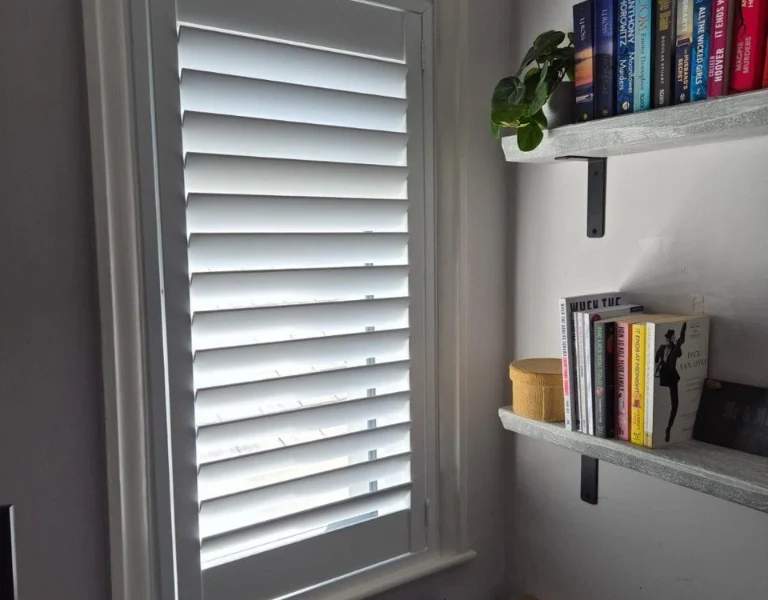 After photo: white full height plantation shutters fitted to the side window in Rawdon, Leeds.