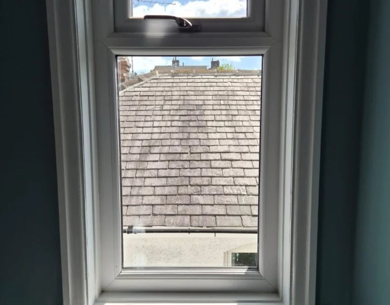 Before photo: side window on a teal feature wall in a Rawdon living room, prior to shutter installation.