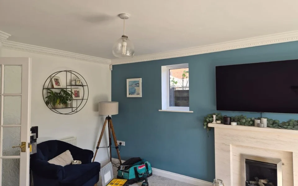Living room in Rawdon during shutter installation, with tools and fittings on the carpet.