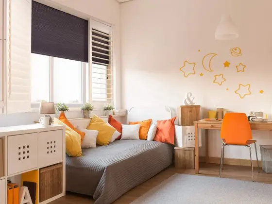 Shutter and shade combination in a bedroom.
