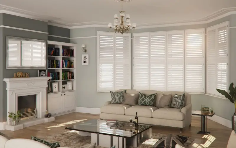 Living room with tier-on-tier bay window shutters and soft furnishings.