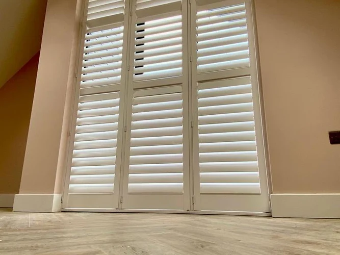 Special shaped shutters installed on a full-height gable-end window.