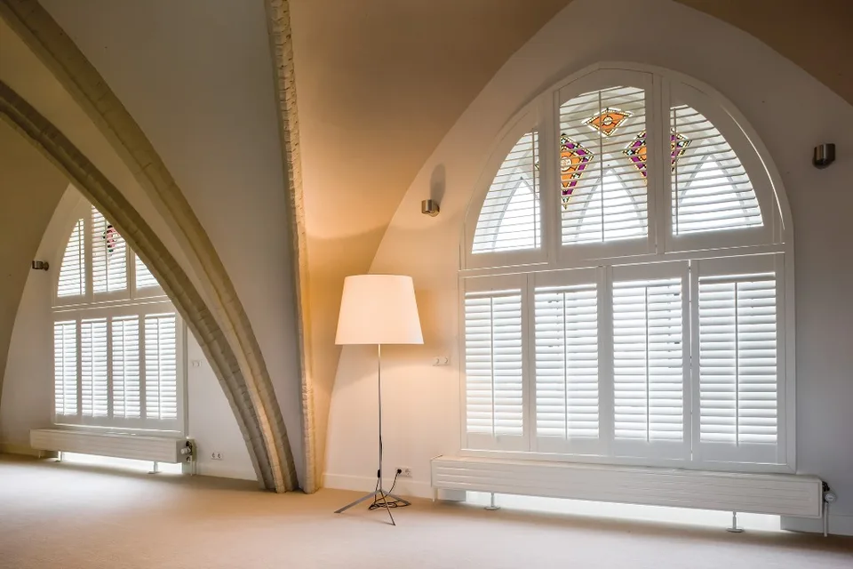 Special shaped shutters fitted to arched windows.