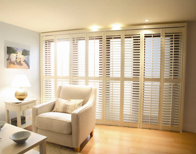 Track shutters fitted across a wide opening with folding bi-fold panels.