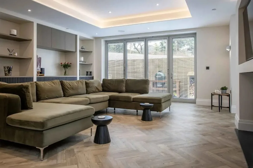 Uni-Blinds integral venetian blinds in bi-folding doors of a modern living room.