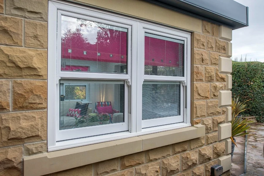 Uni-Blinds integral venetian blinds in a white window set into a Yorkshire stone wall.