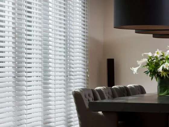 Venetian blinds in a dining room.