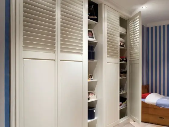 Shutter-style wardrobe doors in a bedroom.