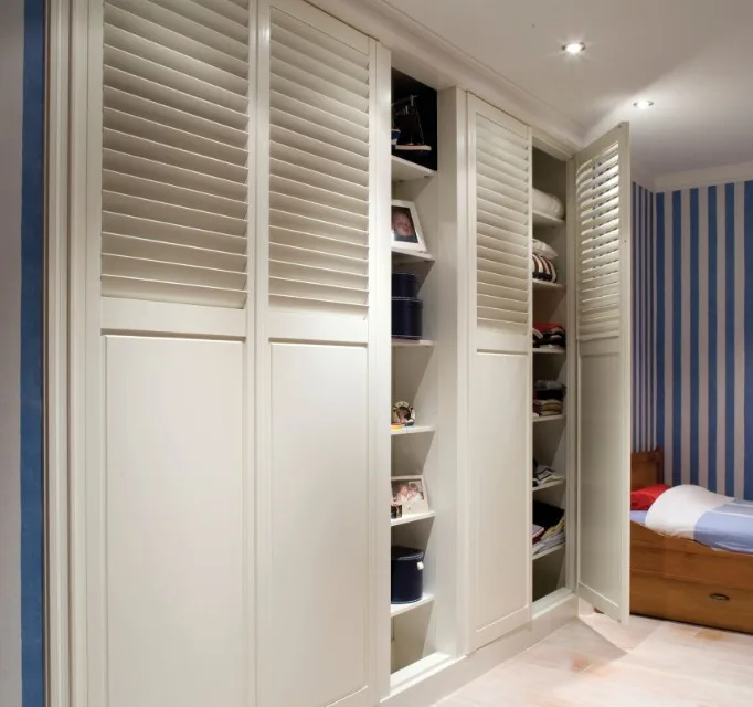 Wardrobe shutter doors fitted on built-in storage.